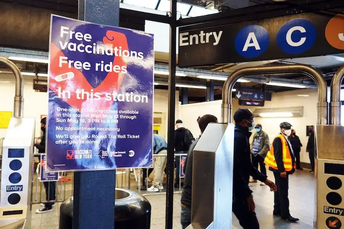 A sign advertising a COVID-19 vaccination at the Broadway Junction subway station in Brooklyn, New York City.